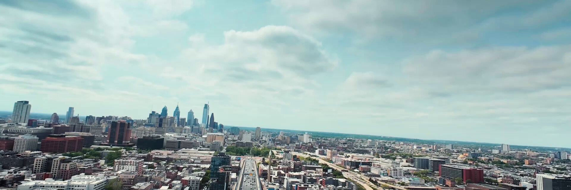 在多云的天空下，现代城市天际线的全景鸟瞰图