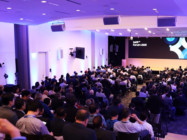The SAFE™ Forum 2025 hosts a full-capacity session in a modern, well-lit conference hall, with attendees focused on a main stage presentation.
