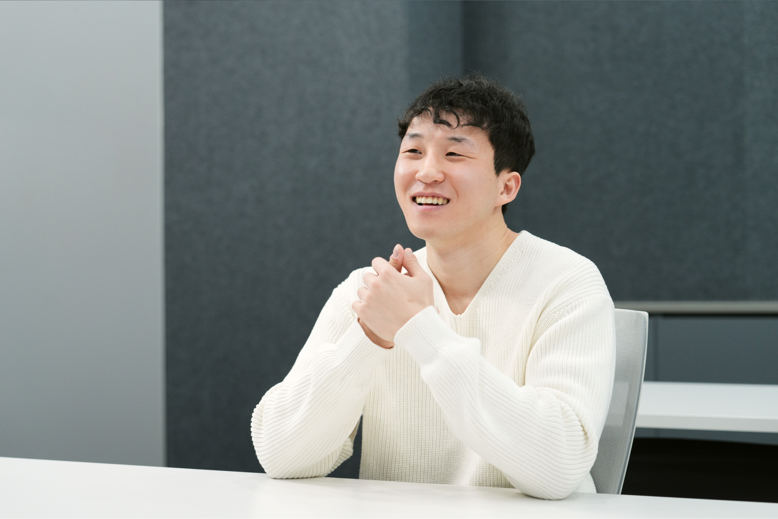 Alex Choi from the Memory Product Planning Team sharing his thoughts with a bright, engaged expression during an interview.