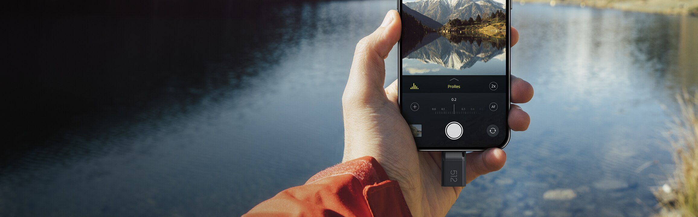 The mobile phone held in one hand has a USB Flash Drive Type-C™ plugged in.
